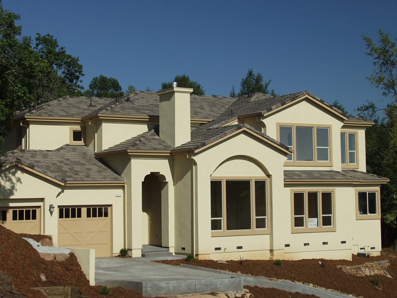 Two-story home with an arched entry and a three-car garage