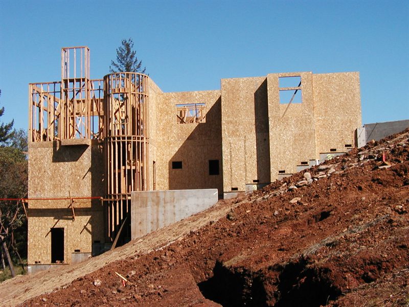Wood framing of a large house on a graded hillside pad