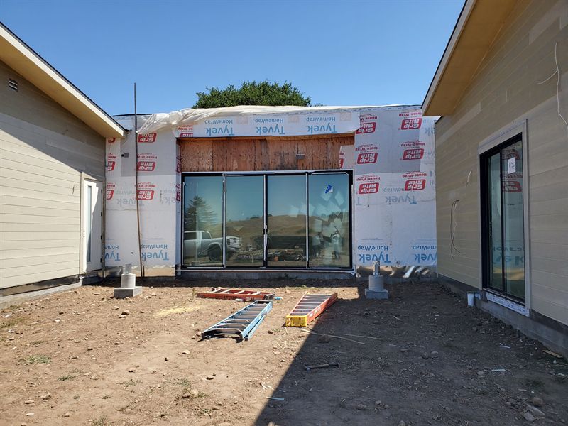 House with windows in and exterior nearly complete, seen from the front