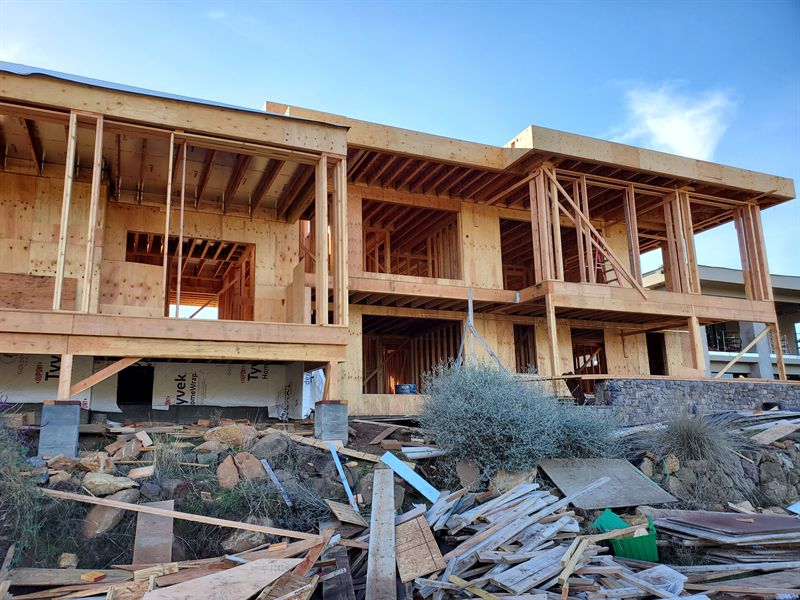 Two-story timber framing of a modern house on a hillside